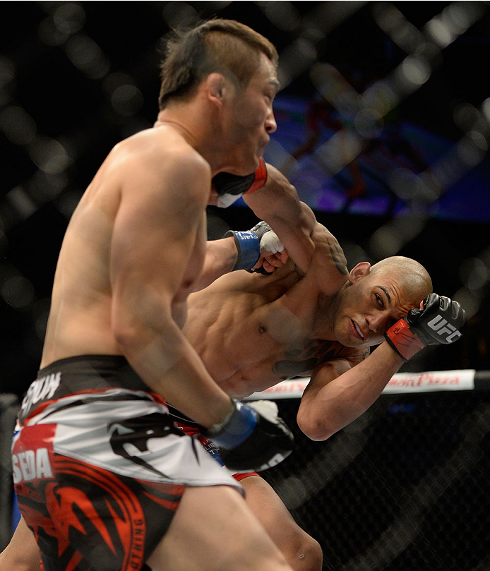 VANCOUVER, BC - JUNE 14: (R-L) Kajan Johnson punches Tae Hyun Bang during the UFC 174 event at Rogers Arena on June 14, 2014 in Vancouver, British Columbia, Canada. (Photo by Jeff Bottari/Zuffa LLC/Zuffa LLC via Getty Images)