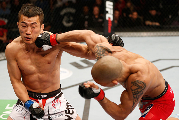 VANCOUVER, BC - JUNE 14: (R-L) Kajan Johnson punches Tae Hyun Bang in their lightweight bout at Rogers Arena on June 14, 2014 in Vancouver, Canada. (Photo by Josh Hedges/Zuffa LLC/Zuffa LLC via Getty Images)