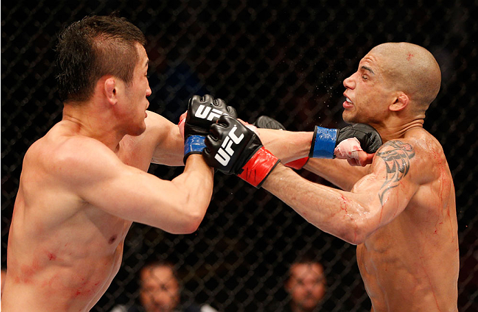 VANCOUVER, BC - JUNE 14: (L-R) Tae Hyun Bang punches Kajan Johnson in their lightweight bout at Rogers Arena on June 14, 2014 in Vancouver, Canada. (Photo by Josh Hedges/Zuffa LLC/Zuffa LLC via Getty Images)