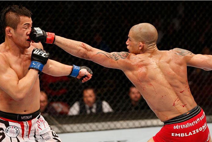 VANCOUVER, BC - JUNE 14: (R-L) Kajan Johnson punches Tae Hyun Bang in their lightweight bout at Rogers Arena on June 14, 2014 in Vancouver, Canada. (Photo by Josh Hedges/Zuffa LLC/Zuffa LLC via Getty Images)