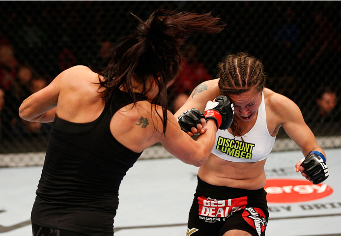 VANCOUVER, BC - JUNE 14: (L-R) Valerie Letourneau punches Elizabeth Phillips in their womens bantamweight bout at Rogers Arena on June 14, 2014 in Vancouver, Canada. (Photo by Josh Hedges/Zuffa LLC/Zuffa LLC via Getty Images)