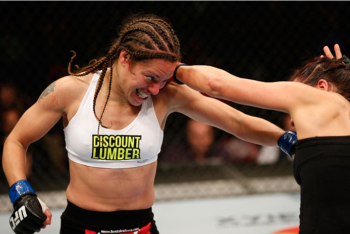 VANCOUVER, BC - JUNE 14: (L-R) Elizabeth Phillips punches Valerie Letourneau in their womens bantamweight bout at Rogers Arena on June 14, 2014 in Vancouver, Canada. (Photo by Josh Hedges/Zuffa LLC/Zuffa LLC via Getty Images)