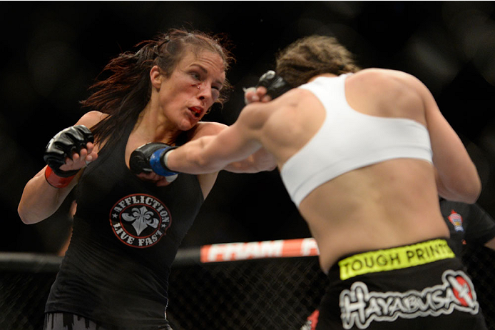 VANCOUVER, BC - JUNE 14: Valerie Latourneau punches Elizabeth Phillips during the UFC 174 event at Rogers Arena on June 14, 2014 in Vancouver, British Columbia, Canada. (Photo by Jeff Bottari/Zuffa LLC/Zuffa LLC via Getty Images)