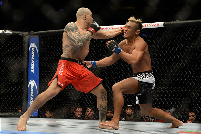 VANCOUVER, BC - JUNE 14: (L-R) Daniel Sarafian punches Kiichi Kunimoto during the UFC 174 event at Rogers Arena on June 14, 2014 in Vancouver, British Columbia, Canada. (Photo by Jeff Bottari/Zuffa LLC/Zuffa LLC via Getty Images)
