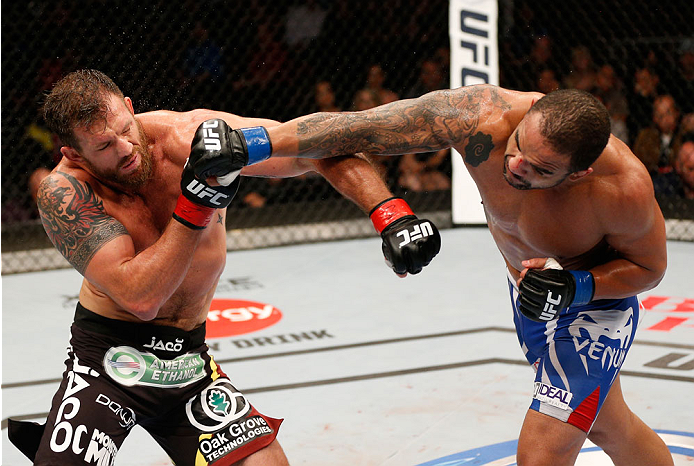 VANCOUVER, BC - JUNE 14: (R-L) Rafael "Feijao" Cavalcante punches Ryan Bader in their light heavyweight bout at Rogers Arena on June 14, 2014 in Vancouver, Canada. (Photo by Josh Hedges/Zuffa LLC/Zuffa LLC via Getty Images)