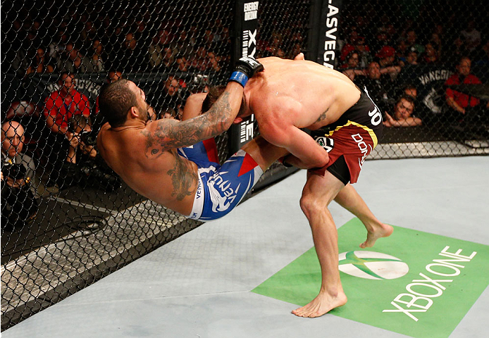 VANCOUVER, BC - JUNE 14: (R-L) Ryan Bader takes down Rafael "Feijao" Cavalcante in their light heavyweight bout at Rogers Arena on June 14, 2014 in Vancouver, Canada. (Photo by Josh Hedges/Zuffa LLC/Zuffa LLC via Getty Images)
