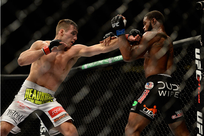 VANCOUVER, BC - JUNE 14: (L-R) Rory MacDonald punches Tyron Woodley during the UFC 174 event at Rogers Arena on June 14, 2014 in Vancouver, British Columbia, Canada. (Photo by Jeff Bottari/Zuffa LLC/Zuffa LLC via Getty Images)