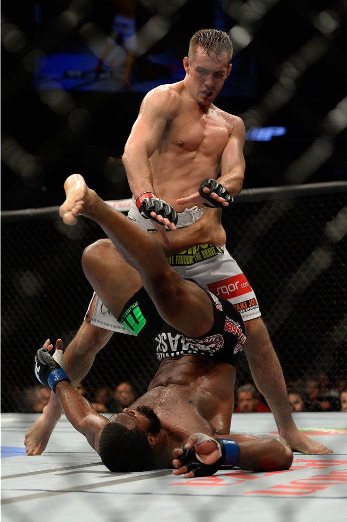 VANCOUVER, BC - JUNE 14: (L-R) Rory MacDonald attacks Tyron Woodley during the UFC 174 event at Rogers Arena on June 14, 2014 in Vancouver, British Columbia, Canada. (Photo by Jeff Bottari/Zuffa LLC/Zuffa LLC via Getty Images)