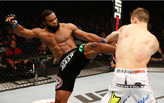 VANCOUVER, BC - JUNE 14: (L-R) Tyron Woodley kicks Rory MacDonald in their welterweight bout at Rogers Arena on June 14, 2014 in Vancouver, Canada. (Photo by Josh Hedges/Zuffa LLC/Zuffa LLC via Getty Images)