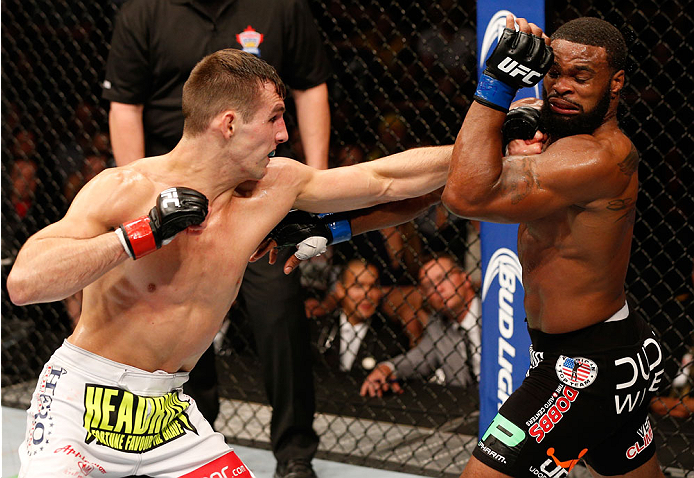 VANCOUVER, BC - JUNE 14: (L-R) Rory MacDonald punches Tyron Woodley in their welterweight bout at Rogers Arena on June 14, 2014 in Vancouver, Canada. (Photo by Josh Hedges/Zuffa LLC/Zuffa LLC via Getty Images)