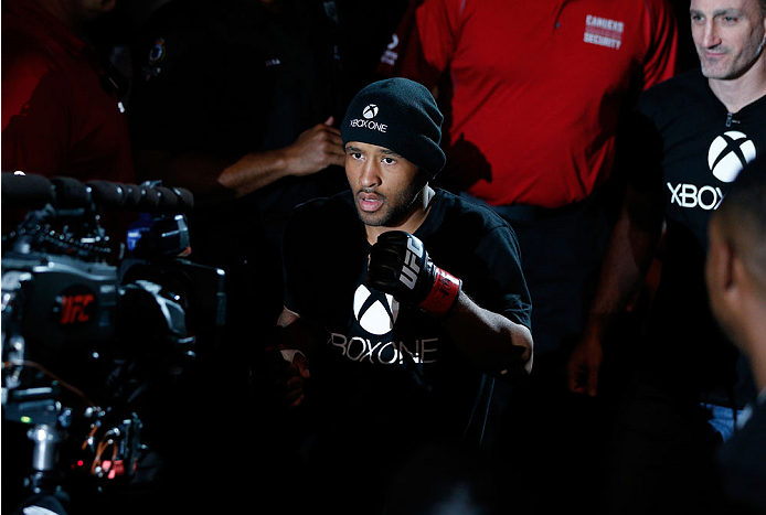 VANCOUVER, BC - JUNE 14: UFC Flyweight Champion Demetrious 'Mighty Mouse' Johnson enters the arena before facing challenger Ali Bagautinov in their UFC flyweight championship bout at Rogers Arena on June 14, 2014 in Vancouver, Canada. (Photo by Josh Hed