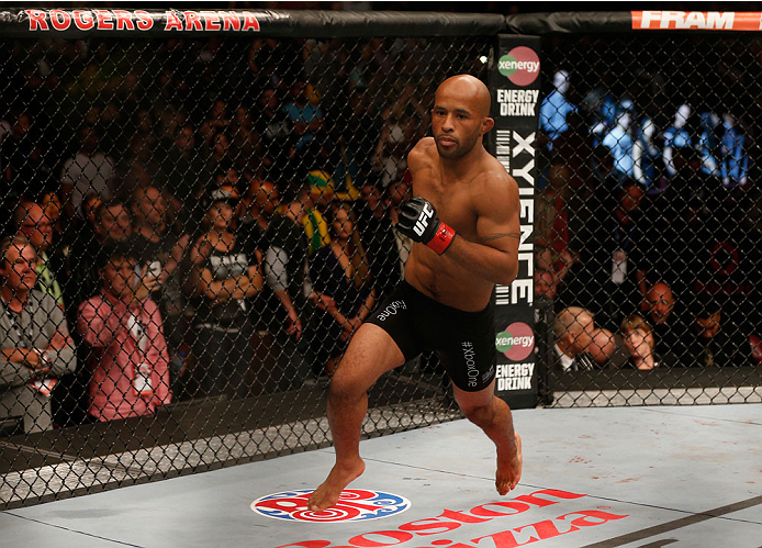 VANCOUVER, BC - JUNE 14: UFC Flyweight Champion Demetrious 'Mighty Mouse' Johnson enters the Octagon before facing challenger Ali Bagautinov in their UFC flyweight championship bout at Rogers Arena on June 14, 2014 in Vancouver, Canada. (Photo by Josh H