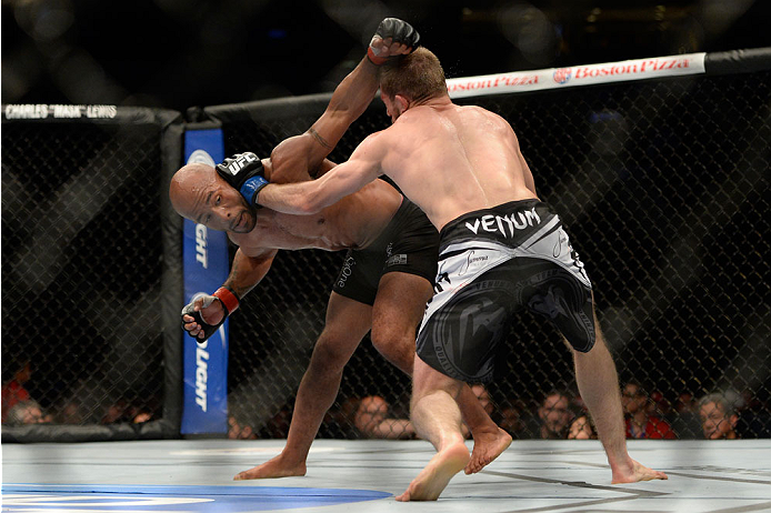 VANCOUVER, BC - JUNE 14: (L-R) UFC Flyweight Champion Demetrious 'Mighty Mouse' Johnson punches Ali Bagautinov during their flyweight championship bout at the UFC 174 event at Rogers Arena on June 14, 2014 in Vancouver, British Columbia, Canada. (Photo b