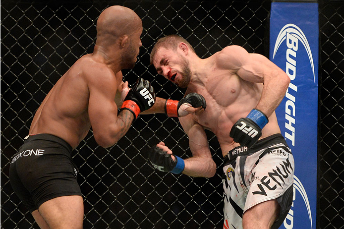 VANCOUVER, BC - JUNE 14: (L-R) UFC Flyweight Champion Demetrious 'Mighty Mouse' Johnson punches Ali Bagautinov during their flyweight championship bout at the UFC 174 event at Rogers Arena on June 14, 2014 in Vancouver, British Columbia, Canada. (Photo b