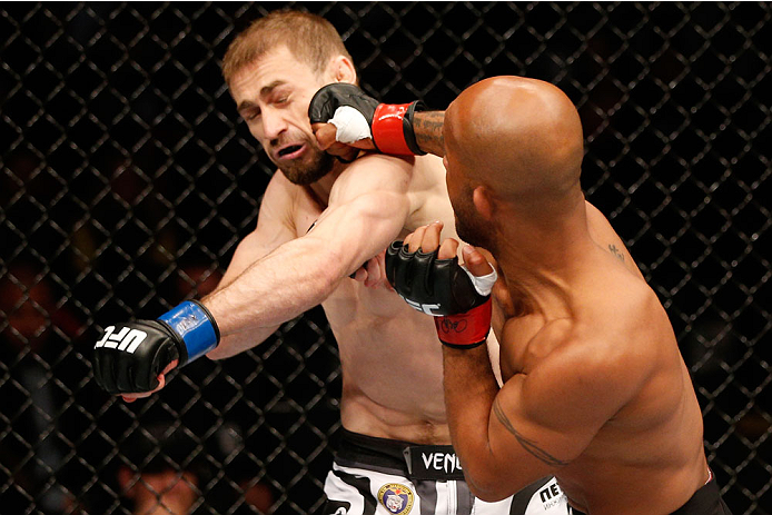 VANCOUVER, BC - JUNE 14: (R-L) Demtrious 'Mighty Mouse' Johnson punches Ali Bagautinov in their UFC flyweight championship bout at Rogers Arena on June 14, 2014 in Vancouver, Canada. (Photo by Josh Hedges/Zuffa LLC/Zuffa LLC via Getty Images)