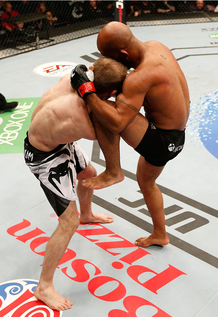 VANCOUVER, BC - JUNE 14: (R-L) Demetrious "Mighty Mouse" Johnson knees Ali Bagautinov in their UFC flyweight championship bout at Rogers Arena on June 14, 2014 in Vancouver, Canada. (Photo by Josh Hedges/Zuffa LLC/Zuffa LLC via Getty Images)