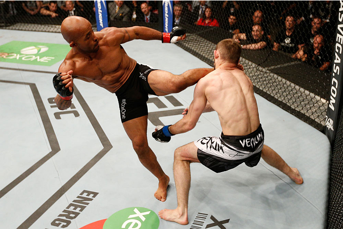 VANCOUVER, BC - JUNE 14: (L-R) Demtrious 'Mighty Mouse' Johnson kicks Ali Bagautinov in their UFC flyweight championship bout at Rogers Arena on June 14, 2014 in Vancouver, Canada. (Photo by Josh Hedges/Zuffa LLC/Zuffa LLC via Getty Images)