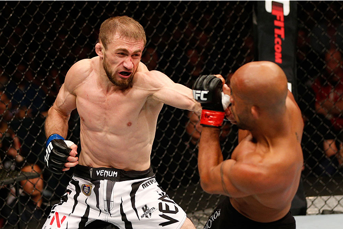 VANCOUVER, BC - JUNE 14: (L-R) Ali Bagautinov punches Demtrious 'Mighty Mouse' Johnson in their UFC flyweight championship bout at Rogers Arena on June 14, 2014 in Vancouver, Canada. (Photo by Josh Hedges/Zuffa LLC/Zuffa LLC via Getty Images)