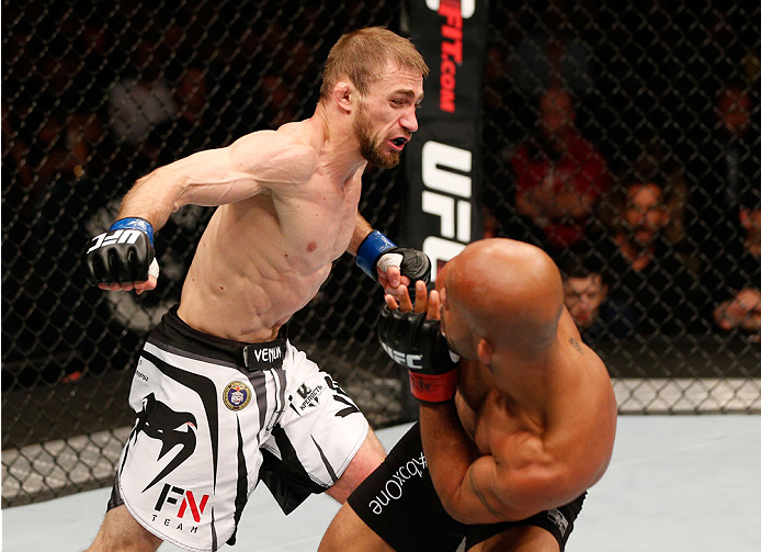 VANCOUVER, BC - JUNE 14: (L-R) Ali Bagautinov fires a punch at Demetrious "Mighty Mouse" Johnson in their UFC flyweight championship bout at Rogers Arena on June 14, 2014 in Vancouver, Canada. (Photo by Josh Hedges/Zuffa LLC/Zuffa LLC via Getty Images)