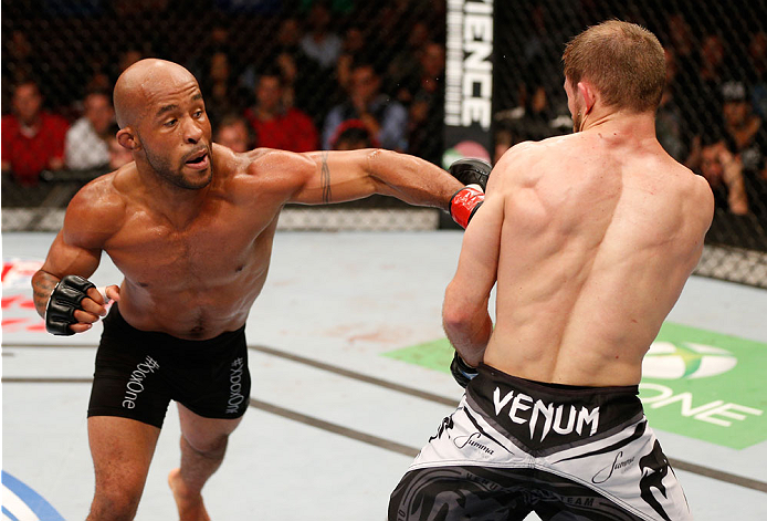 VANCOUVER, BC - JUNE 14: (L-R) Demetrious "Mighty Mouse" Johnson delivers a punch against Ali Bagautinov in their UFC flyweight championship bout at Rogers Arena on June 14, 2014 in Vancouver, Canada. (Photo by Josh Hedges/Zuffa LLC/Zuffa LLC via Getty