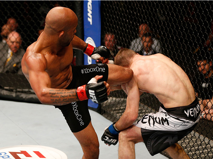 VANCOUVER, BC - JUNE 14: (L-R) Demetrious "Mighty Mouse" Johnson kicks Ali Bagautinov in their UFC flyweight championship bout at Rogers Arena on June 14, 2014 in Vancouver, Canada. (Photo by Josh Hedges/Zuffa LLC/Zuffa LLC via Getty Images)