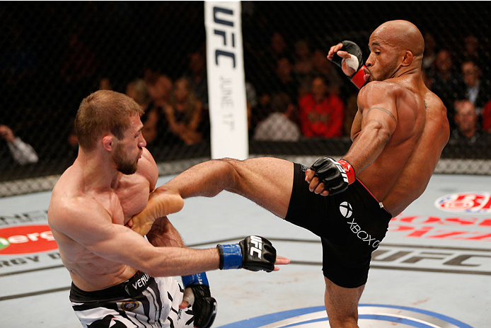 VANCOUVER, BC - JUNE 14: (R-L) Demtrious 'Mighty Mouse' Johnson kicks Ali Bagautinov in their UFC flyweight championship bout at Rogers Arena on June 14, 2014 in Vancouver, Canada. (Photo by Josh Hedges/Zuffa LLC/Zuffa LLC via Getty Images)
