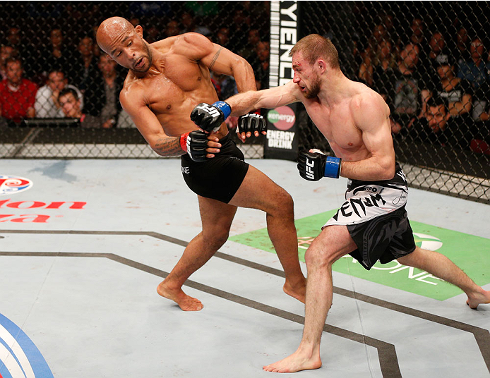 VANCOUVER, BC - JUNE 14: (R-L) Ali Bagautinov punches Demetrious "Mighty Mouse" Johnson in their UFC flyweight championship bout at Rogers Arena on June 14, 2014 in Vancouver, Canada. (Photo by Josh Hedges/Zuffa LLC/Zuffa LLC via Getty Images)