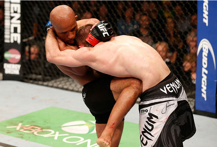 VANCOUVER, BC - JUNE 14: (L-R) Demetrious "Mighty Mouse" Johnson knees Ali Bagautinov in their UFC flyweight championship bout at Rogers Arena on June 14, 2014 in Vancouver, Canada. (Photo by Josh Hedges/Zuffa LLC/Zuffa LLC via Getty Images)