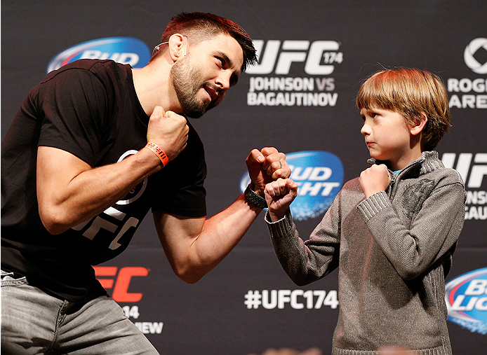 VANCOUVER, BC - JUNE 13: Carlos Condit poses for photos with young fans after a Q&A session before the UFC 174 weigh-in at Rogers Arena on June 13, 2014 in Vancouver, Canada. (Photo by Josh Hedges/Zuffa LLC/Zuffa LLC via Getty Images)