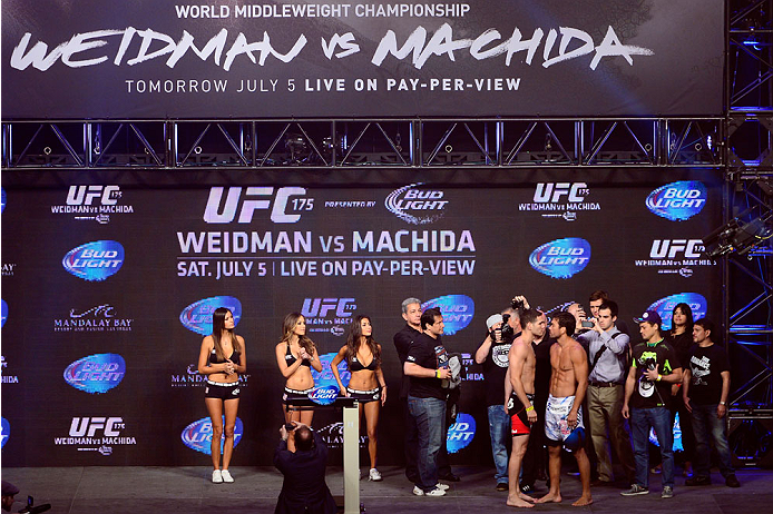LAS VEGAS, NV - JULY 4: UFC Middleweight Champion Chris Weidman (L) and challenger Lyoto Machida face off during the UFC 175 weigh-in inside the Mandalay Bay Events Center on July 4, 2014 in Las Vegas, Nevada. (Photo by Jeff Bottari/Zuffa LLC/Zuffa LLC v
