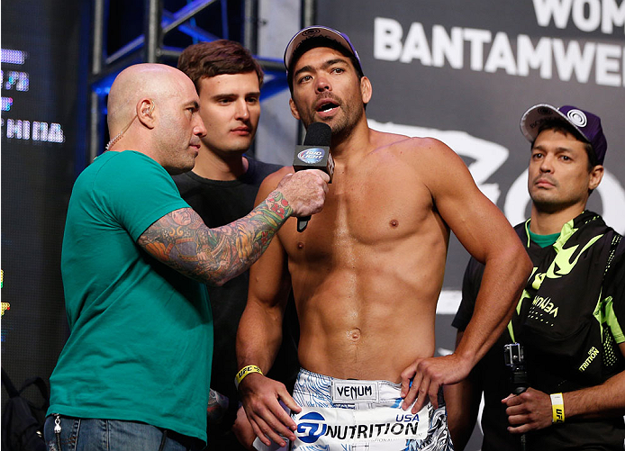 LAS VEGAS, NV - JULY 04: (L-R) Joe Rogan talks with Lyoto Machida during the UFC 175 weigh-in inside the Mandalay Bay Events Center on July 4, 2014 in Las Vegas, Nevada. (Photo by Josh Hedges/Zuffa LLC/Zuffa LLC via Getty Images)