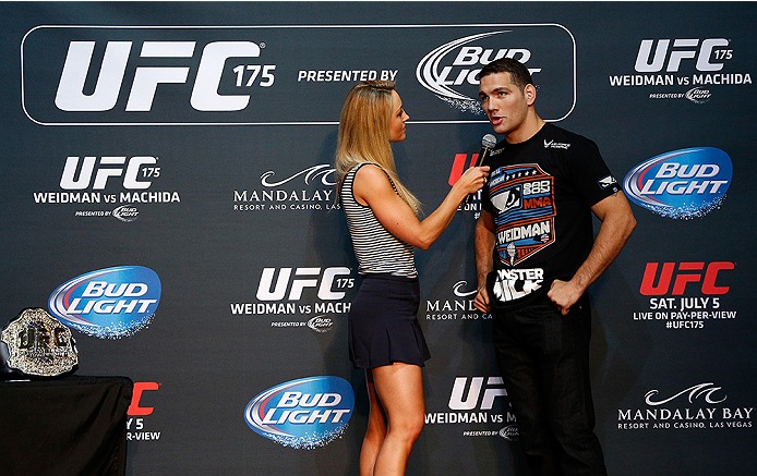 LAS VEGAS, NV - JULY 02: (R-L) UFC middleweight champion Chris Weidman is interviewed by Carolyn Pearce before an open training session ahead of UFC 175 at the Fashion Show Mall on July 2, 2014 in Las Vegas, Nevada. (Photo by Josh Hedges/Zuffa LLC/Zuffa