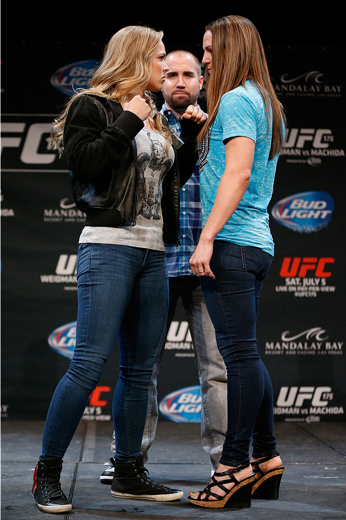 LAS VEGAS, NV - JULY 03: (L-R) Opponents Ronda Rousey and Alexis Davis face off during the UFC Ultimate Media Day at the Mandalay Bay Resort and Casino on July 3, 2014 in Las Vegas, Nevada. (Photo by Josh Hedges/Zuffa LLC/Zuffa LLC via Getty Images)