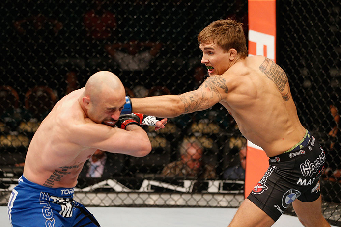 LAS VEGAS, NV - SEPTEMBER 27: (R-L) Cody Gibson punches Manvel Gamburyan in their bantamweight fight during the UFC 178 event inside the MGM Grand Garden Arena on September 27, 2014 in Las Vegas, Nevada. (Photo by Josh Hedges/Zuffa LLC/Zuffa LLC via Get