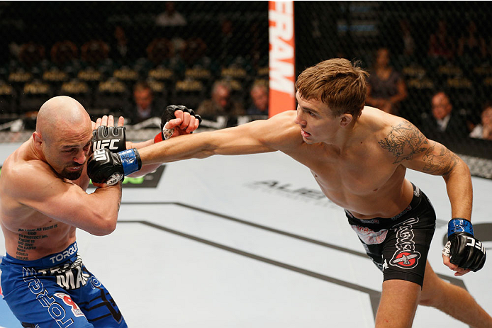 LAS VEGAS, NV - SEPTEMBER 27: (R-L) Cody Gibson punches Manvel Gamburyan in their bantamweight fight during the UFC 178 event inside the MGM Grand Garden Arena on September 27, 2014 in Las Vegas, Nevada. (Photo by Josh Hedges/Zuffa LLC/Zuffa LLC via Get