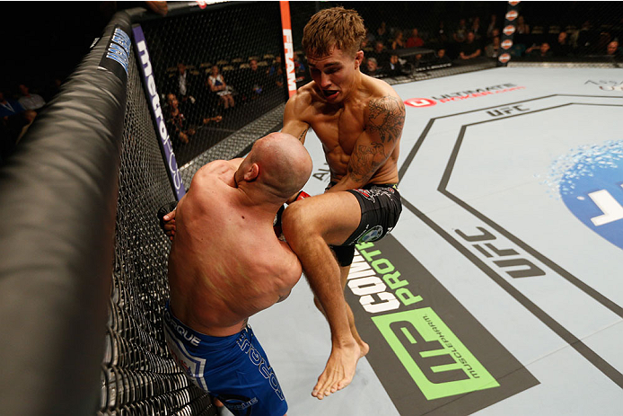 LAS VEGAS, NV - SEPTEMBER 27: Cody Gibson knees Manvel Gamburyan in their bantamweight fight during the UFC 178 event inside the MGM Grand Garden Arena on September 27, 2014 in Las Vegas, Nevada. (Photo by Josh Hedges/Zuffa LLC/Zuffa LLC via Getty Images
