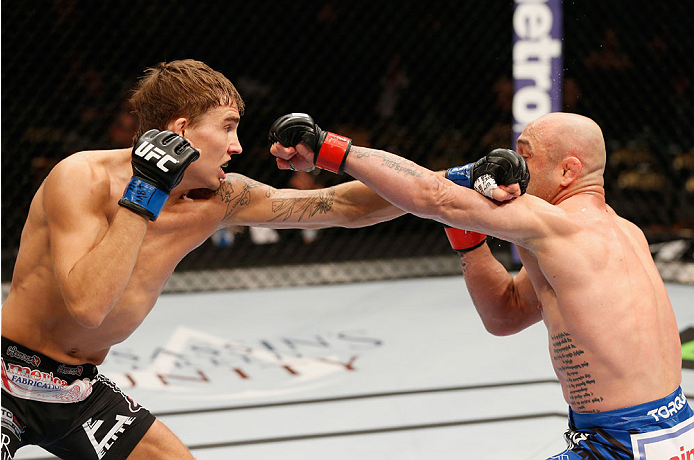 LAS VEGAS, NV - SEPTEMBER 27: (L-R) Cody Gibson punches Manvel Gamburyan in their bantamweight fight during the UFC 178 event inside the MGM Grand Garden Arena on September 27, 2014 in Las Vegas, Nevada. (Photo by Josh Hedges/Zuffa LLC/Zuffa LLC via Get