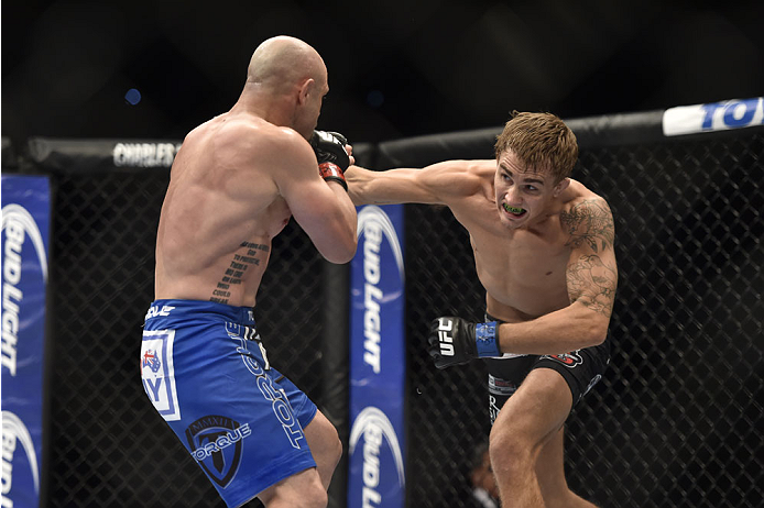LAS VEGAS, NV - SEPTEMBER 27: (R-L) Cody Gibson punches Manval Gamburyan in their bantamweight fight during the UFC 178 event inside the MGM Grand Garden Arena on September 27, 2014 in Las Vegas, Nevada. (Photo by Jeff Bottari/Zuffa LLC/Zuffa LLC via Ge