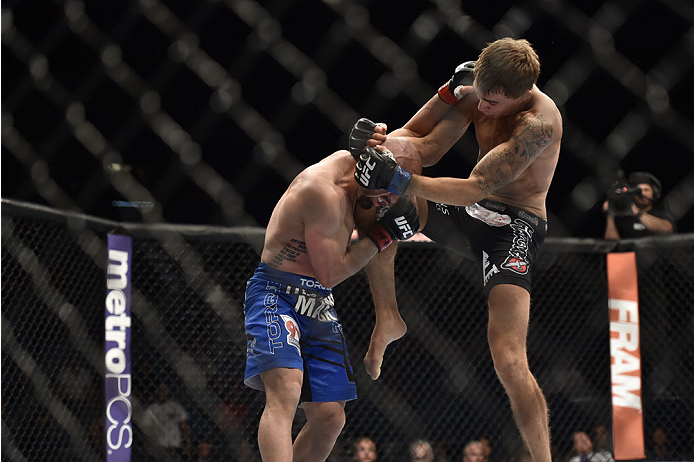 LAS VEGAS, NV - SEPTEMBER 27: (R-L) Cody Gibson knees Manval Gamburyan in their bantamweight fight during the UFC 178 event inside the MGM Grand Garden Arena on September 27, 2014 in Las Vegas, Nevada. (Photo by Jeff Bottari/Zuffa LLC/Zuffa LLC via Gett
