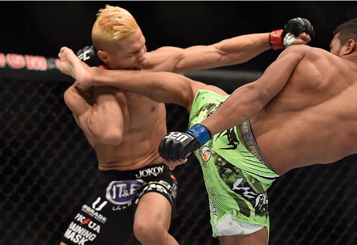LAS VEGAS, NV - SEPTEMBER 27: (R-L) Kevin Lee kicks Jon Tuck in their lightweight fight during the UFC 178 event inside the MGM Grand Garden Arena on September 27, 2014 in Las Vegas, Nevada. (Photo by Jeff Bottari/Zuffa LLC/Zuffa LLC via Getty Images)