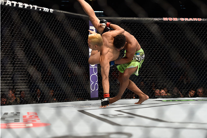 LAS VEGAS, NV - SEPTEMBER 27: (R-L) Kevin Lee takes down Jon Tuck in their lightweight fight during the UFC 178 event inside the MGM Grand Garden Arena on September 27, 2014 in Las Vegas, Nevada. (Photo by Jeff Bottari/Zuffa LLC/Zuffa LLC via Getty Image