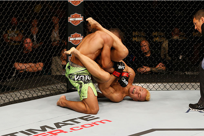 LAS VEGAS, NV - SEPTEMBER 27: (R-L) Jon Tuck attempts an arm bar on Kevin Lee in their lightweight fight during the UFC 178 event inside the MGM Grand Garden Arena on September 27, 2014 in Las Vegas, Nevada. (Photo by Josh Hedges/Zuffa LLC/Zuffa LLC via