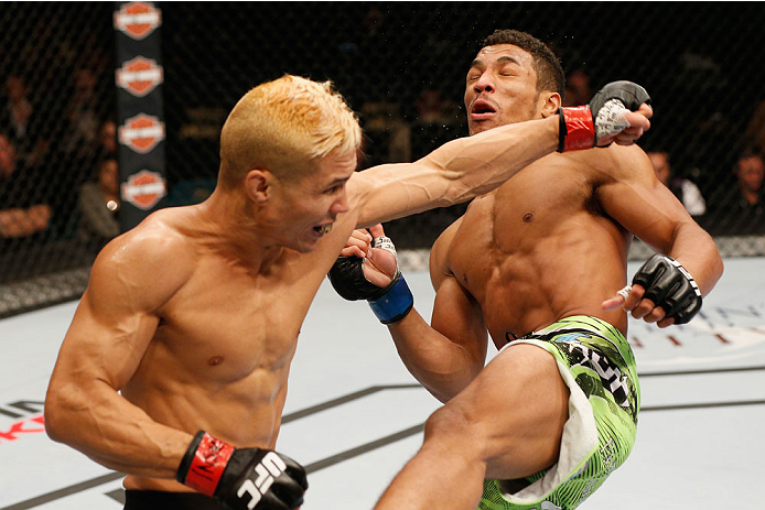 LAS VEGAS, NV - SEPTEMBER 27: (L-R) Jon Tuck punches Kevin Lee in their lightweight fight during the UFC 178 event inside the MGM Grand Garden Arena on September 27, 2014 in Las Vegas, Nevada. (Photo by Josh Hedges/Zuffa LLC/Zuffa LLC via Getty Images)