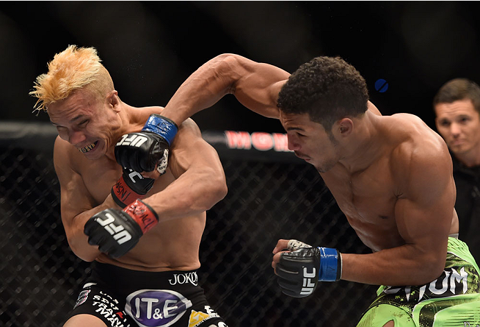 LAS VEGAS, NV - SEPTEMBER 27: Kevin Lee punches Jon Tuck in their lightweight fight during the UFC 178 event inside the MGM Grand Garden Arena on September 27, 2014 in Las Vegas, Nevada. (Photo by Jeff Bottari/Zuffa LLC/Zuffa LLC via Getty Images)