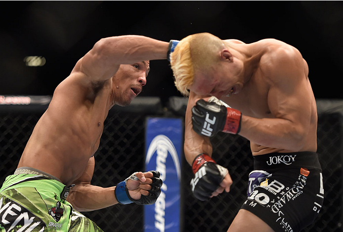 LAS VEGAS, NV - SEPTEMBER 27: Kevin Lee punches Jon Tuck in their lightweight fight during the UFC 178 event inside the MGM Grand Garden Arena on September 27, 2014 in Las Vegas, Nevada. (Photo by Jeff Bottari/Zuffa LLC/Zuffa LLC via Getty Images)