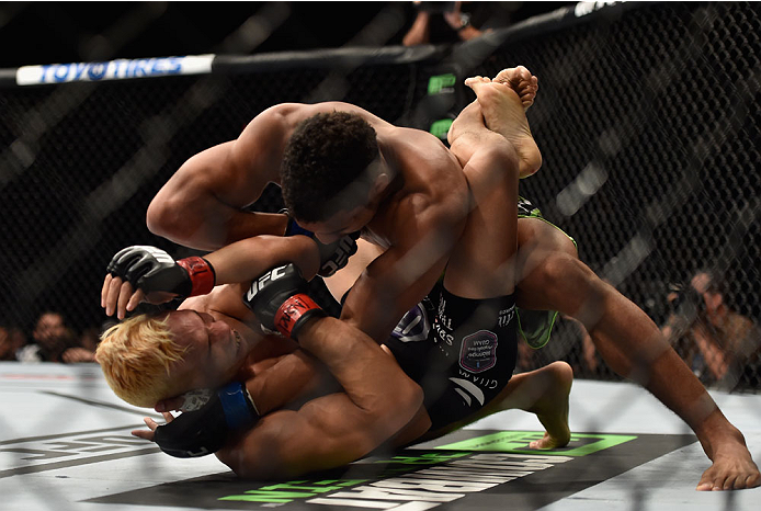 LAS VEGAS, NV - SEPTEMBER 27: Kevin Lee controls the body of Jon Tuck in their lightweight fight during the UFC 178 event inside the MGM Grand Garden Arena on September 27, 2014 in Las Vegas, Nevada. (Photo by Jeff Bottari/Zuffa LLC/Zuffa LLC via Getty