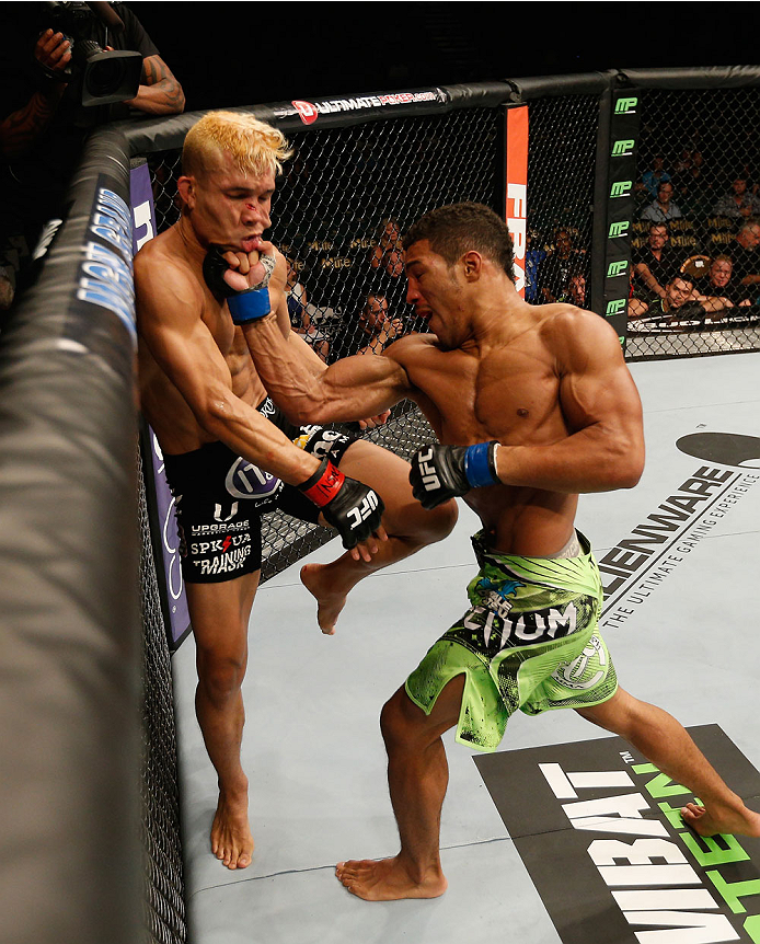 LAS VEGAS, NV - SEPTEMBER 27: (L-R) Kevin Lee punches Jon Tuck in their lightweight fight during the UFC 178 event inside the MGM Grand Garden Arena on September 27, 2014 in Las Vegas, Nevada. (Photo by Josh Hedges/Zuffa LLC/Zuffa LLC via Getty Images)