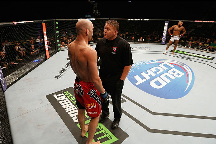 LAS VEGAS, NV - SEPTEMBER 27: (L-R) Brian Ebersole is given a warning for an illegal upkick against John Howard in their welterweight fight during the UFC 178 event inside the MGM Grand Garden Arena on September 27, 2014 in Las Vegas, Nevada. (Photo by