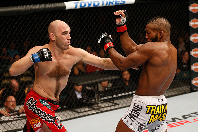 LAS VEGAS, NV - SEPTEMBER 27: (L-R) Brian Ebersole punches John Howard in their welterweight fight during the UFC 178 event inside the MGM Grand Garden Arena on September 27, 2014 in Las Vegas, Nevada. (Photo by Josh Hedges/Zuffa LLC/Zuffa LLC via Getty