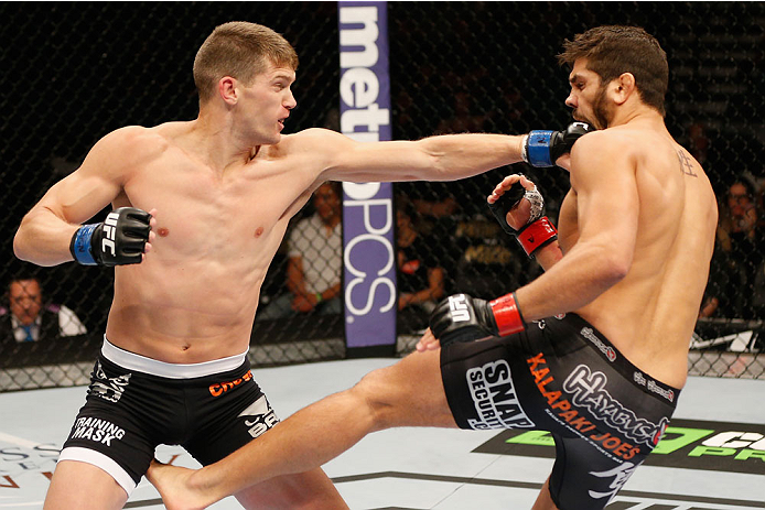 LAS VEGAS, NV - SEPTEMBER 27: (L-R) Josh Thompson punches Patrick Cote in their welterweight fight during the UFC 178 event inside the MGM Grand Garden Arena on September 27, 2014 in Las Vegas, Nevada. (Photo by Josh Hedges/Zuffa LLC/Zuffa LLC via Getty